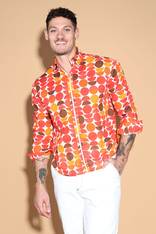 Exude a fun retro vibe of the sixties and seventies that makes for a fun look in this shirt. In warm tones of reds, oranges and yellows, the overall circle print shirt has a shirt collar and front button closure with full sleeves. Trimmed and complimented with white details that finish off the look giving it just the polished look needed. Style this fun retro shirt with white pants or denims or white shorts.