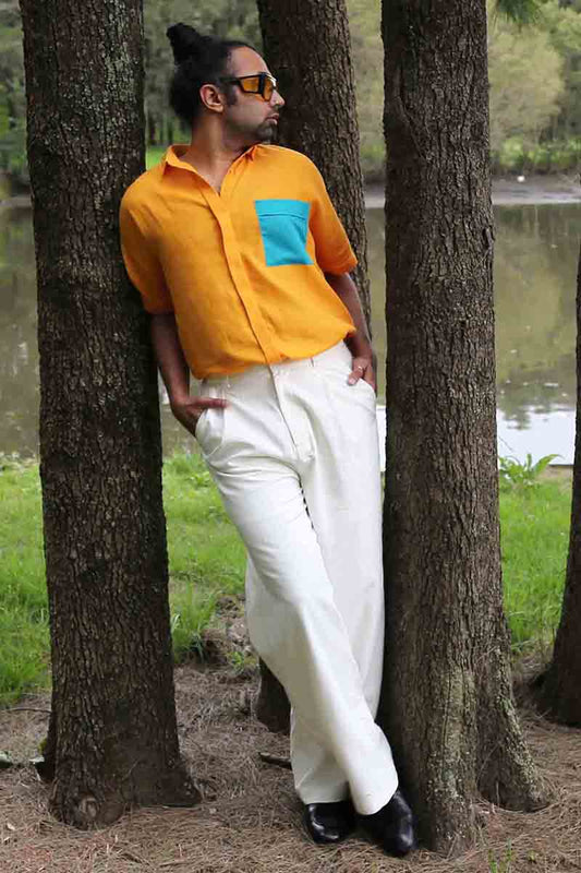 An easy breathable cotton shirt is a perfect summer staple. The shirt in a woven cotton in a striking yellow turns heads for all the right reasons. With a front short and dip hem, the shirt has an accent teal pocket that gives it extra dimension. Short sleeves and a collared neckline in a relaxed cotton are all you need this season for an easy breezy look. 